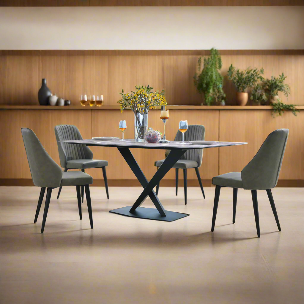 Dining table with four chairs in a modern room with large windows.